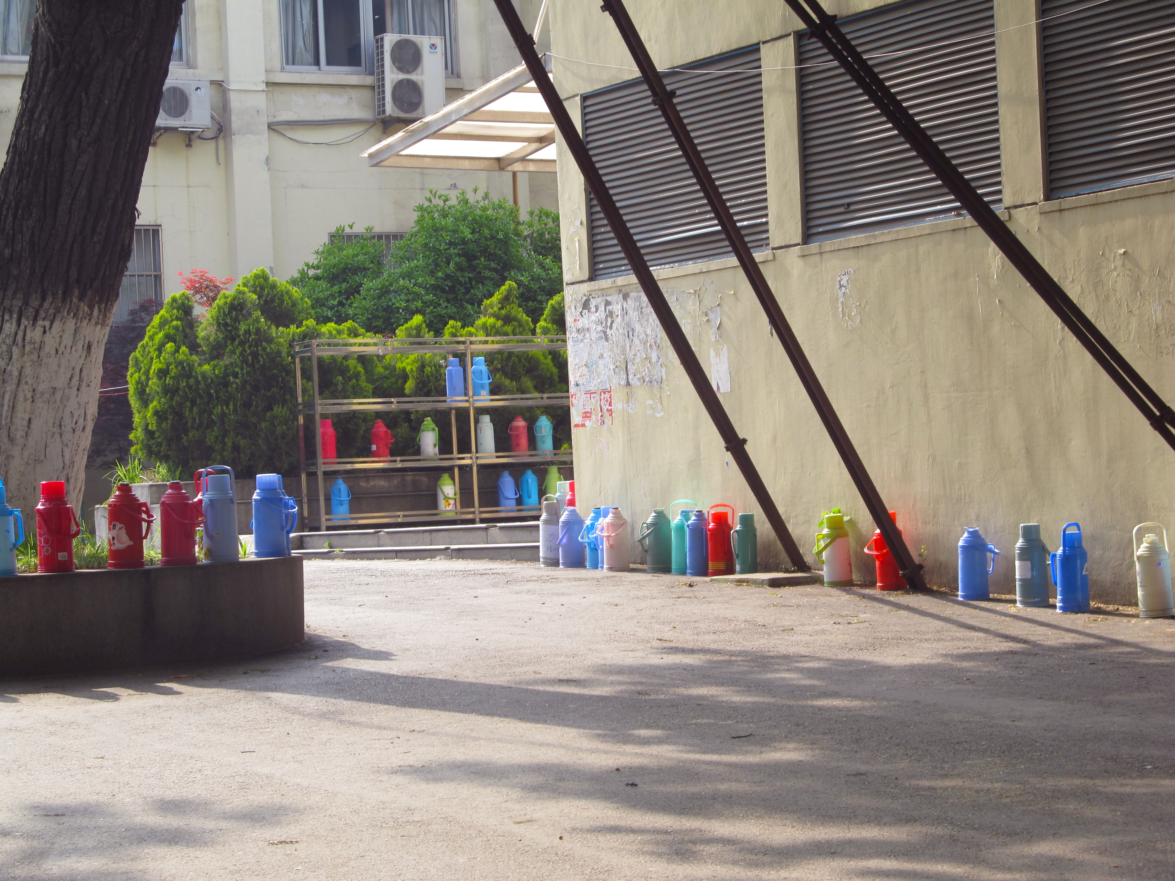 Hot water thermos bottles waiting to be filled on Nanjing University's campus.