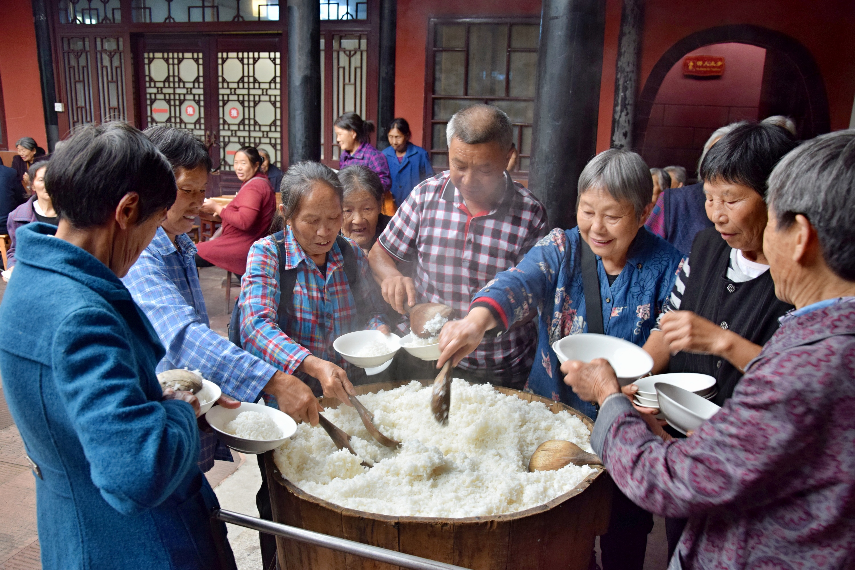Diners serve themselves rice at a temple restaurant in Sichuan