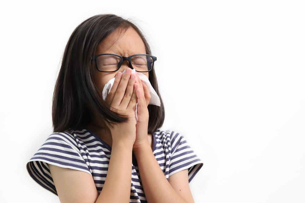 Photo of young Chinese girl sneezing