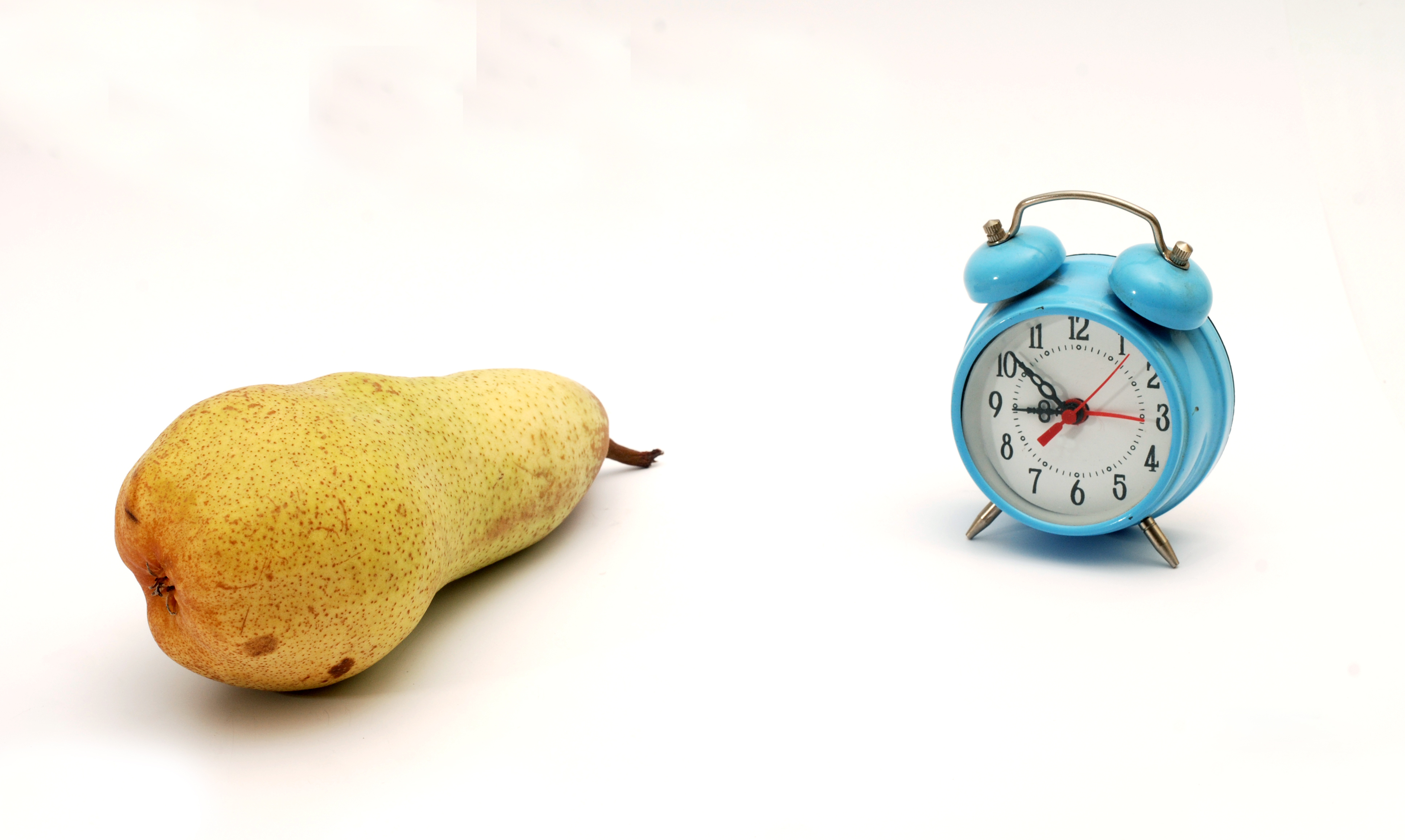 Pear and a clock on a white background.